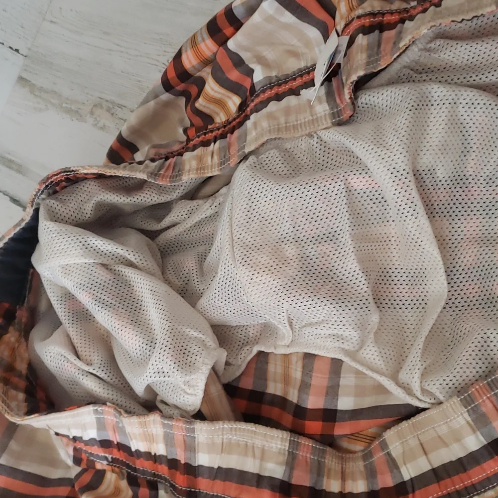 Old Navy plaid swim shorts tan, orange, brown. Pockets, built in brief. Size XXL